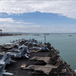 USS Abraham Lincoln flight deck lined with fighter jets as the carrier arrives at Laem Chabang port in Thailand