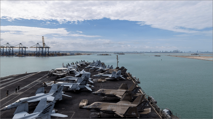 USS Abraham Lincoln flight deck lined with fighter jets as the carrier arrives at Laem Chabang port in Thailand