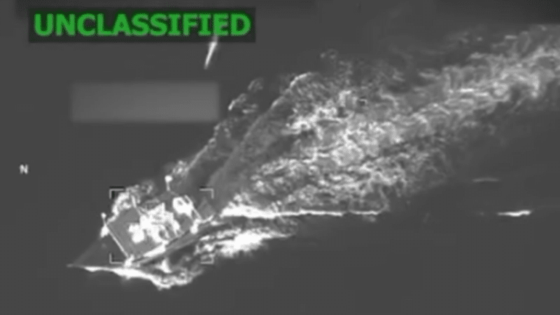 Still from Department of Defense surveillance video showing a US missile descending toward a boat in the Caribbean Sea