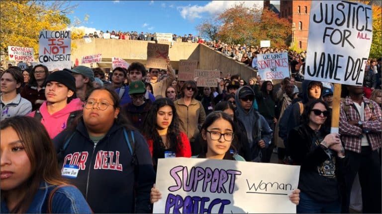 Cornell University students hold protest signs reading "Justice for Jane Doe," "Alcohol is not consent" and "We want sentences not essays" at a rally on Ho Plaza in Ithaca, New York